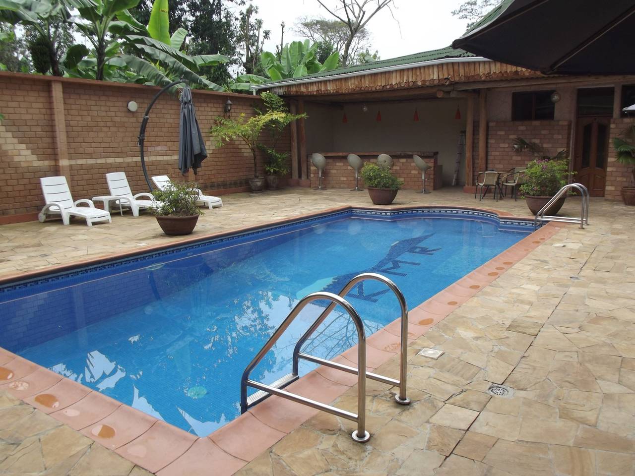 Swimming pool with a stone paver deck